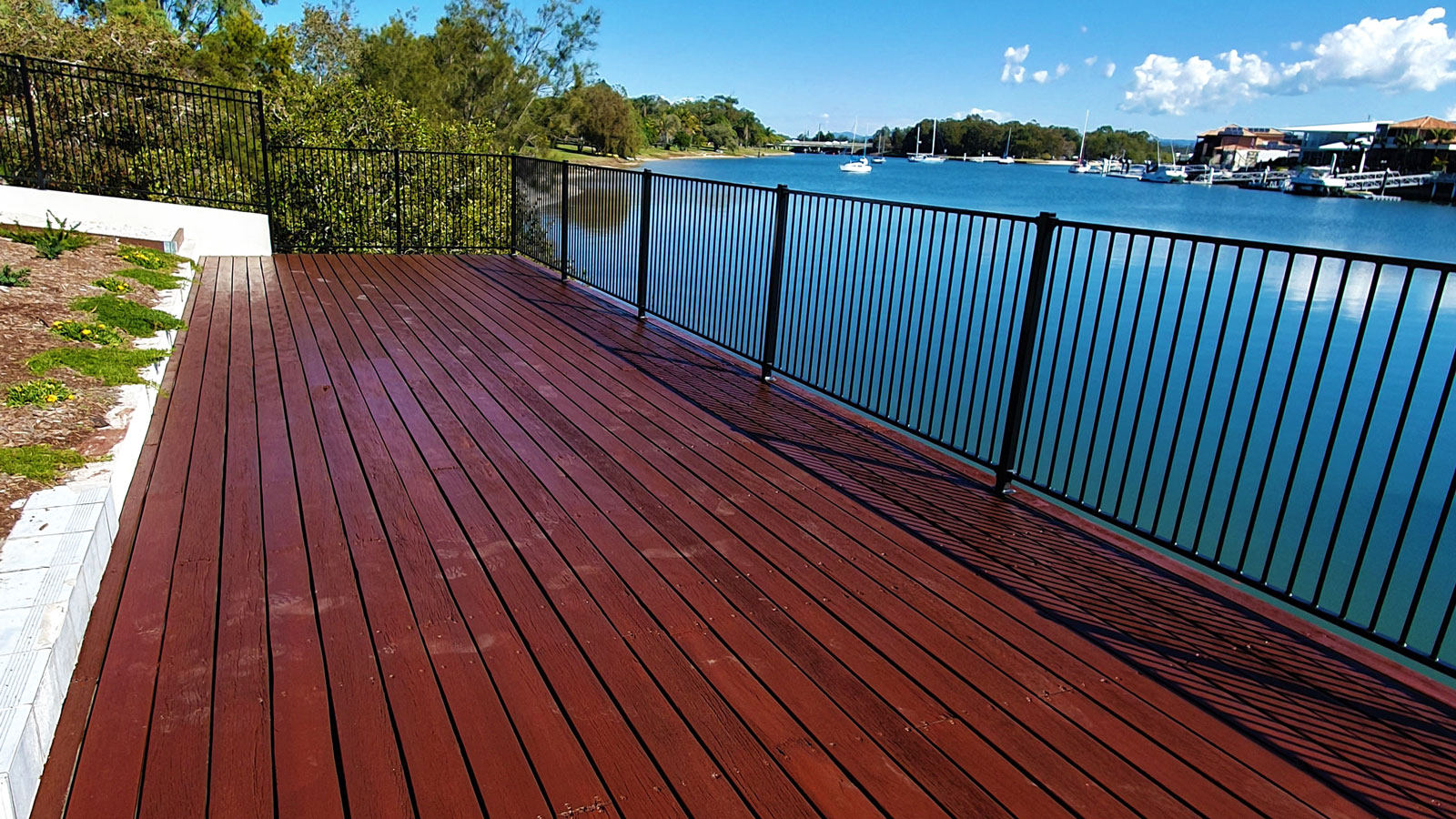 timber decking with railings near the lake
