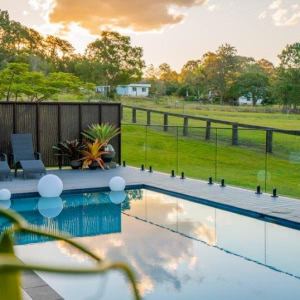 decking around a pool and sunset view