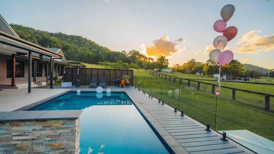 decking around a pool, balloons and sunset view